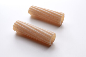 small composition of whole durum wheat pasta on a white background