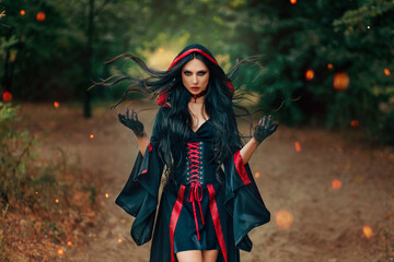 Fantasy woman witch creates magic, hands raised long hair flying in wind motion. Sexy face dark...
