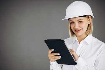 Woman architect reading engineer plan on tablet