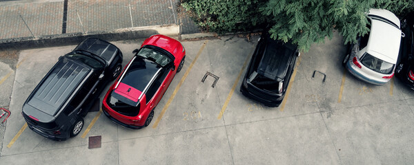 Different cars is parking on concrete sidewalk in courtyard top view