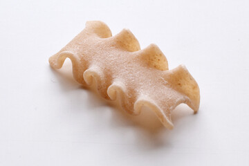 small composition of whole durum wheat pasta on a white background