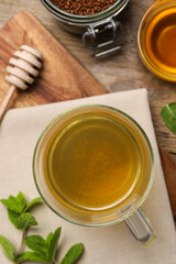 Buckwheat tea, granules and honey on wooden table, flat lay