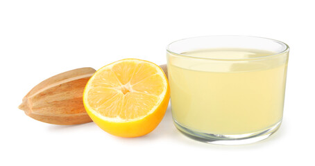 Freshly squeezed juice, half of lemon and reamer on white background