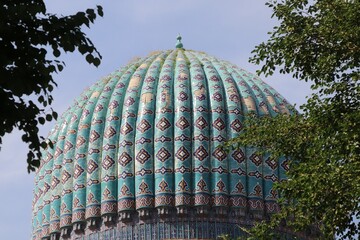 Blue dome islamic architecture with pattern mausoleum in blue sky close up