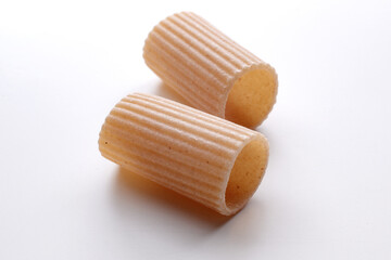 small composition of whole durum wheat pasta on a white background