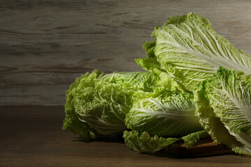 Fresh ripe Chinese cabbages on wooden table