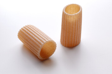 small composition of whole durum wheat pasta on a white background