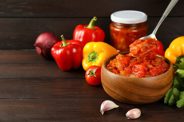 Tasty lecho and fresh ingredients on wooden table. Space for text