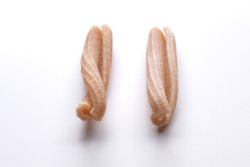 small composition of whole durum wheat pasta on a white background