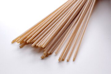 whole wheat durum wheat pasta on wooden background