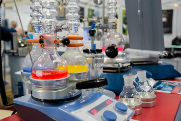 Heating mantle for flasks with multicolored liquid in chemical laboratory. Science, pharmaceutical,...