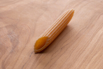 whole wheat durum wheat pasta on wooden background