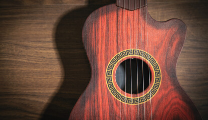 Guitar on the wooden background.