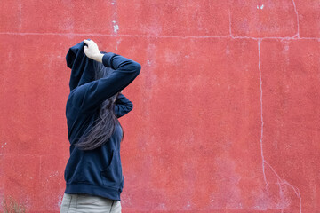 Women putting hood on from side view