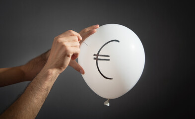 Fototapeta na wymiar Man hold needle directed to balloon. Euro symbol on balloon