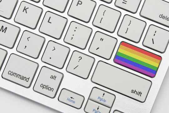 gay pride flag on the keyboard on a grey background .3d illustration