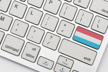 national flag of luxembourg on the keyboard on a grey background .3d illustration