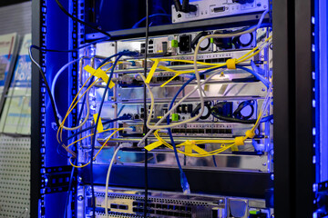 Telecommunication technology equipment - fiber optic cables and switch at server room, data center. Network, transfer, traffic, web, hardware, connection and internet concept