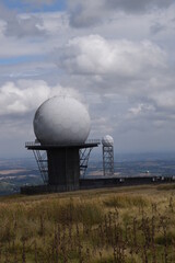 a view of the radar station at Titterstone Clee summit with the sky clear blue with fluffy clouds