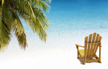 Yellow chair on white sand beach under palm branch. Soft wave of turquoise water.