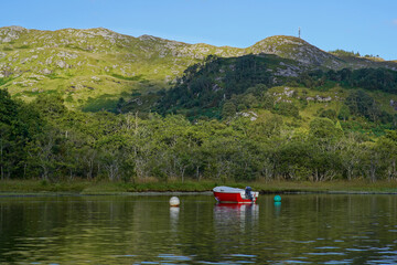 Fototapeta na wymiar A small boat on Loch Shiel in the Scottish highlands