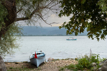 Fishing boats on the shore of Lake Apolyont. Uluabat, G&ouml;lyazı, Bursa, Turkey. Selective Focus Boat.