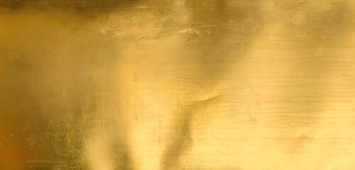 Gold texture background with yellow metallic foil luxury shiny shine glitter sparkle of bright light reflection. Metal bronze golden surface, celebration, banner, wallpaper, design. Gold horizontal