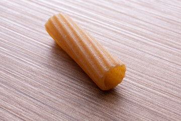 whole wheat durum wheat pasta on wooden background