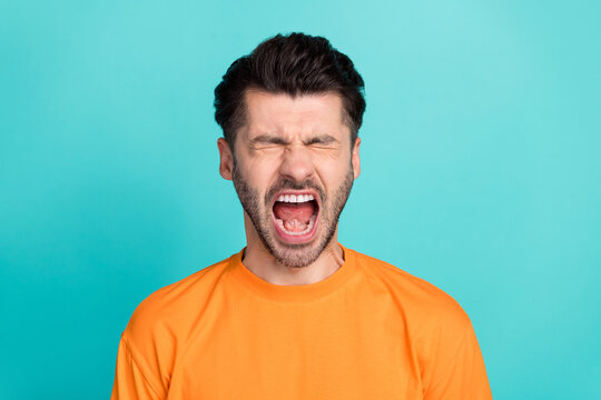 Closeup photo of young attractive handsome bearded man open mouth screaming unhappy depressed deadline isolated on aquamarine color background