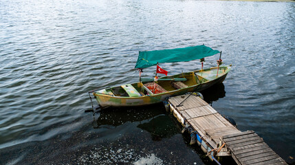 Obraz premium yellow green tour boats on the shore of Lake Apolyont. Uluabat, Golyazı, Bursa, Turkey. Selective Focus Boat.