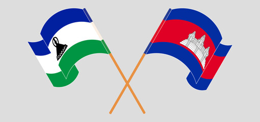 Crossed and waving flags of Lesotho and Cambodia