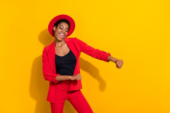 Photo of cute funky short hair person dressed red suit cap smiling dancing isolated yellow color background - Powered by Adobe