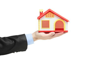 Hand of a businessman holding a house