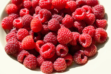 Raspberry berries. Top view raspberries in a plate. Selective focus. Shallow depth of field. Blurred background