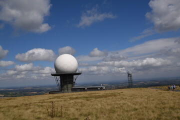 a view of the radar station at Titterstone Clee summit with the sky clear blue with fluffy clouds