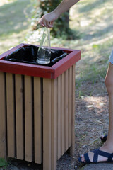 In the hands of two empty glass bottles. Throw away glassware