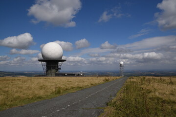 a view of the radar station at Titterstone Clee summit with the sky clear blue with fluffy clouds