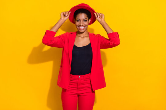 Photo of sweet cute short hair person dressed red suit arms hands cap smiling isolated yellow color background