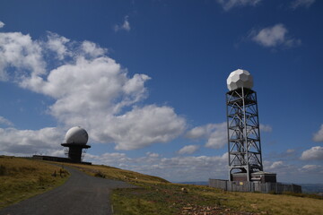 a view of the radar station at Titterstone Clee summit with the sky clear blue with fluffy clouds