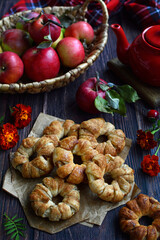 Naklejka na ściany i meble Homemade cake with apples and red apples in a basket on a rustic background. season, harvest