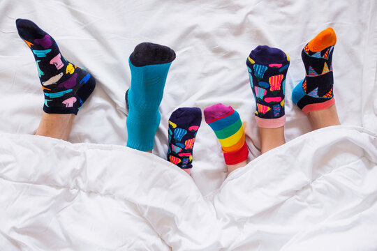 Colorful socks on feet as a symbol of World Down Syndrome Day.