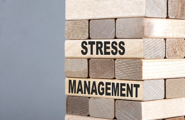 The text on the wooden blocks STRESS MANAGEMENT