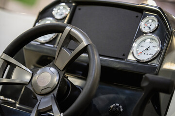 Steering wheel and dashboard of a motor boat.