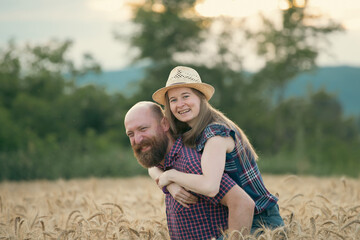 Loving couple in a wheat field.