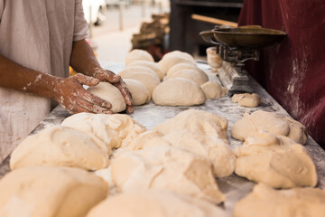 male hands knead yeast dough for baking bread