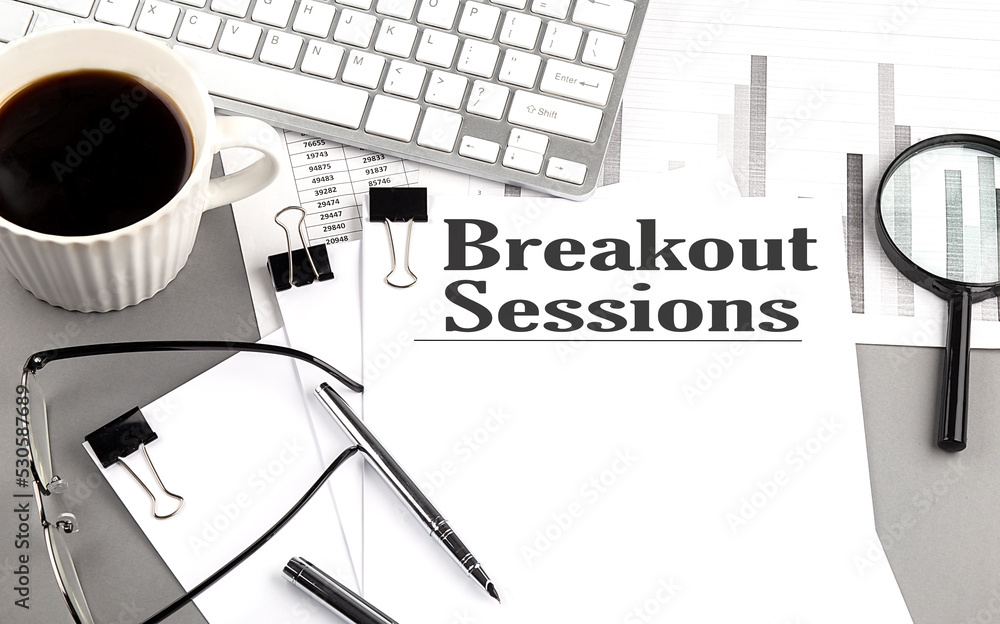 Poster breakout sessions text on a paper with magnifier, coffee and keyboard on grey background