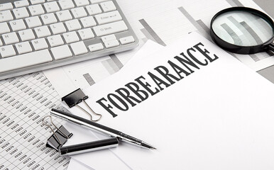 FORBEARANCE text on paper with chart and keyboard, business concept - obrazy, fototapety, plakaty