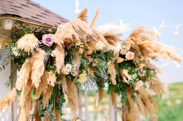 Natural decorations with flowers of wedding ceremony arch outdoors