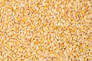 The Gold flax seeds texture as background.