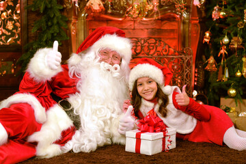 Fototapeta na wymiar Santa Claus in a traditional costume with a girl